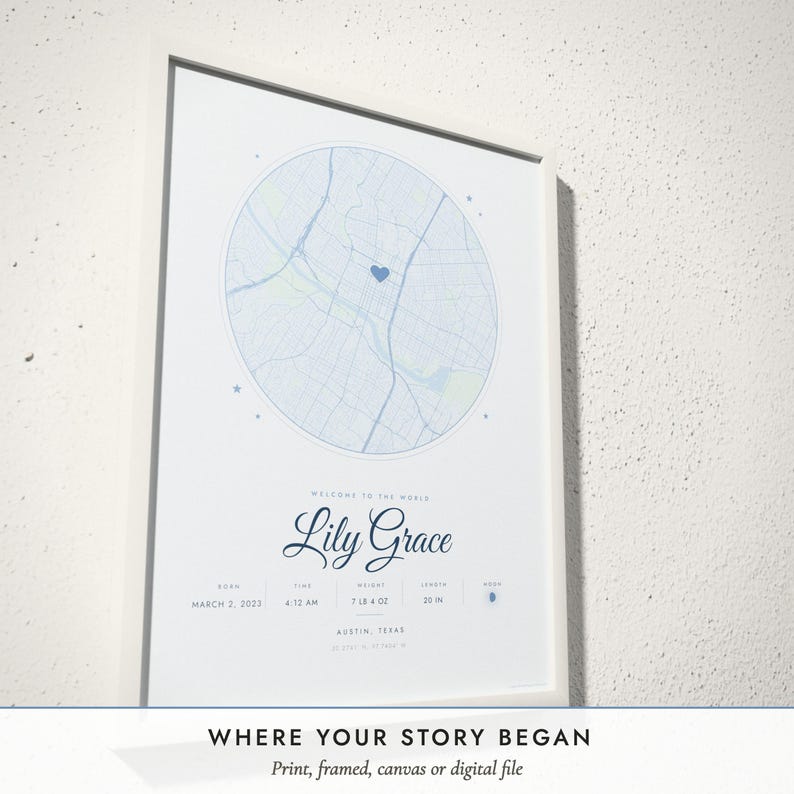 Three-quarter view of the framed Birth Map poster on a white plaster wall