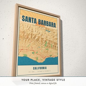 Three-quarter view of the framed Vintage Travel Poster Map poster on a white plaster wall