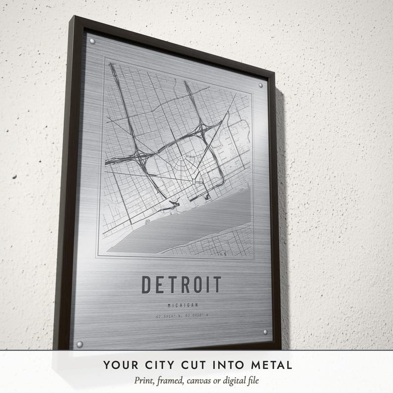 Three-quarter view of the framed Etched Metal City Map poster on a white plaster wall