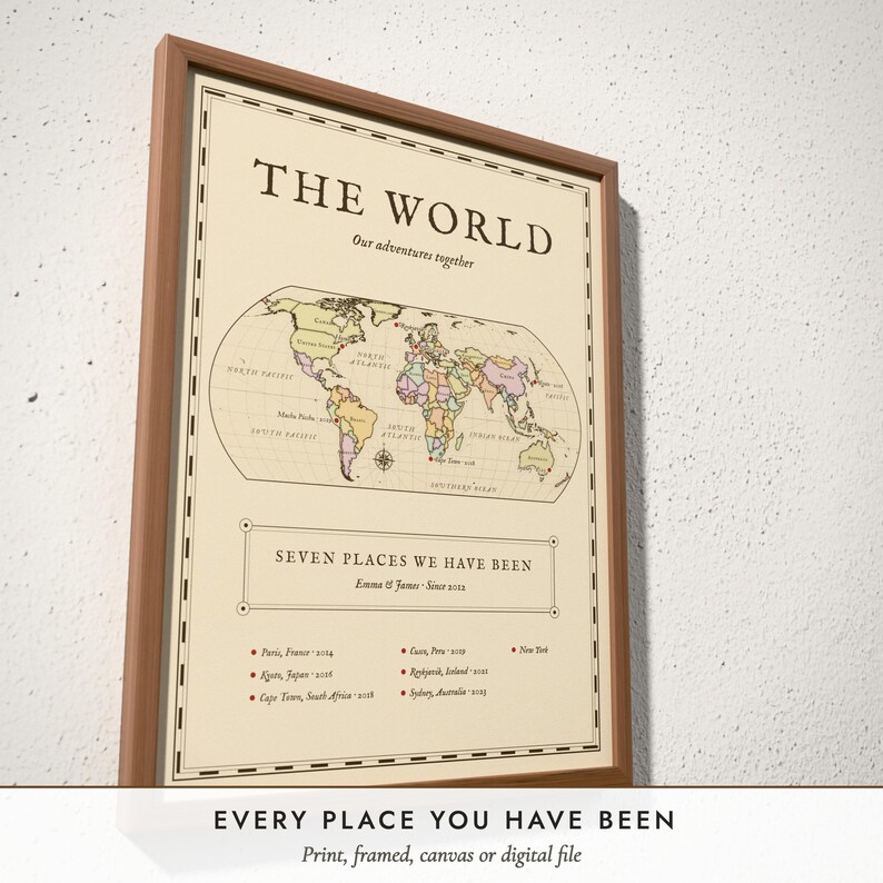 Three-quarter view of the framed Antique World Map poster on a white plaster wall