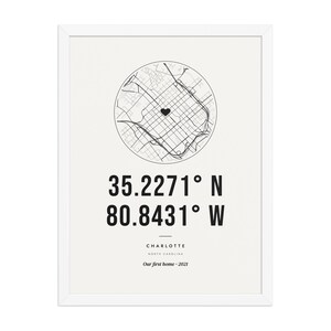 Real product photo: the Custom Coordinates Print in the white wood frame with a clear acrylic front