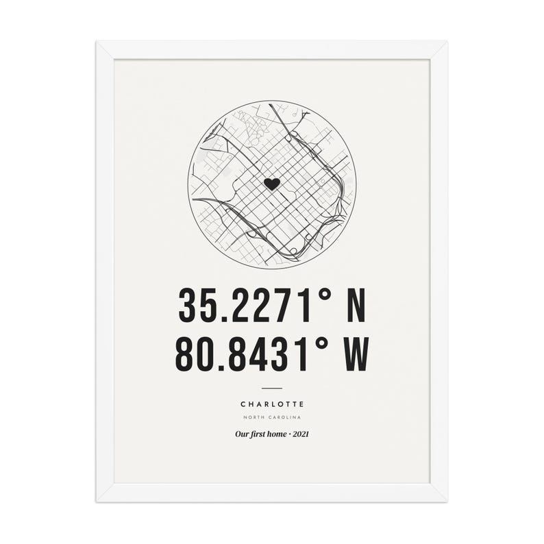 Real product photo: the Custom Coordinates Print in the white wood frame with a clear acrylic front