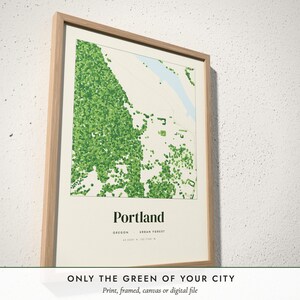 Three-quarter view of the framed Urban Forest Map poster on a white plaster wall