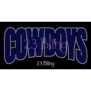 May include: A black background with the word "COWBOYS" in large, blue rhinestone letters. The word "23 Bling" is written in pink script below the word "COWBOYS". The letters are outlined in white rhinestones.