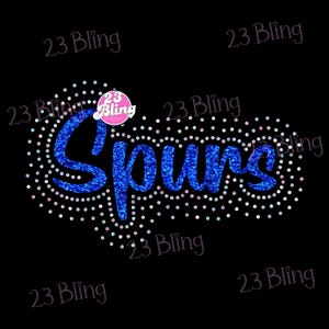 May include: A black background with the word "Spurs" in blue glitter, surrounded by a white dotted outline. The text "23 Bling" is repeated around the image. A pink circle with "23 Bling" is above the word "Spurs".