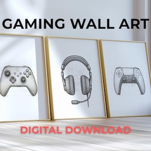 May include: Three framed prints with gold frames featuring gaming-themed illustrations. The prints display a game controller, a headset, and another game controller. The text "GAMING WALL ART" and "DIGITAL DOWNLOAD" are visible.