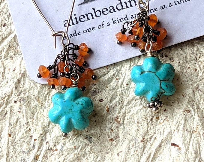 Spira: Turquoise-blue carved flowers with tiny carnelian seed dangles