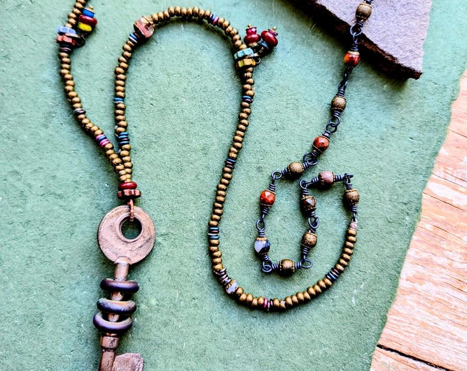 Magic Key: Long artisan flamework pendant strand  - warm neutrals with onyx, carnelian, Czech dangles