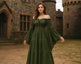 May include: An olive green off-the-shoulder maxi dress with long, flared sleeves. The dress features a fitted bodice and a tiered skirt. The model is standing in front of a stone castle.