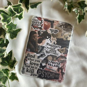 May include: Clear phone case with a collage design. The design includes images of a woman, butterflies, a skull, and text that reads "find what you love and let it kill you" and "I prefer villains".
