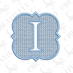 May include: A light blue embroidered letter I with a decorative border. The letter is outlined in a darker blue and has a grid pattern inside.