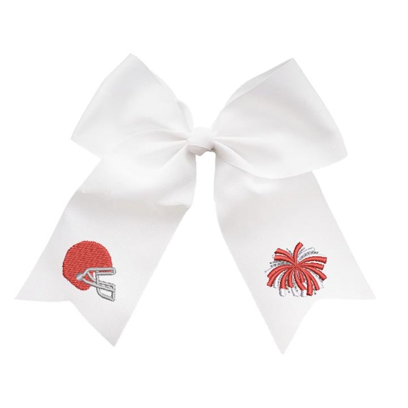 May include: A large white hair bow made of stiff ribbon with two long tails. The left tail features an embroidered red football helmet with a silver facemask, and the right tail features an embroidered red and silver cheerleader pom-pom.