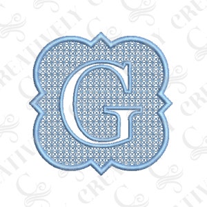 May include: A light blue embroidered monogram with the letter "G" in a decorative frame. The letter is white and the frame is a light blue color.