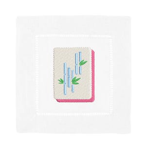 May include: White square linen cocktail napkin with a stitched border. The napkin features an embroidered design of bamboo stalks in blue and green, set against a beige background with a pink border.