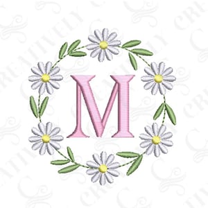May include: Embroidered design of the letter M surrounded by a wreath of white daisies with yellow centers and green leaves.