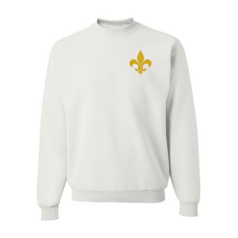 May include: White sweatshirt with a gold embroidered fleur-de-lis on the left chest.