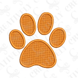 May include: An embroidered orange paw print design, featuring five distinct pads. The design has a textured appearance, with detailed stitching creating a three-dimensional effect. The paw print is centered on a white background.