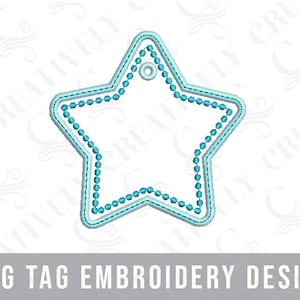 May include: A light blue star-shaped bag tag embroidery design. The tag has a beaded border and a small hole at the top for attaching to a bag. The text "BAG TAG EMBROIDERY DESIGN" is at the bottom.