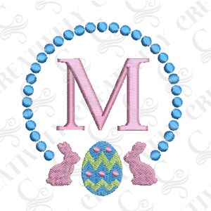 May include: A pink letter M surrounded by a blue beaded circle with two pink bunnies and a green and yellow Easter egg.