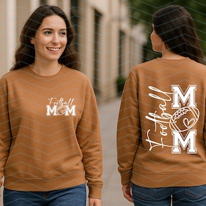 May include: A brown sweatshirt with the text "Football Mom" and a football graphic on the front. The back of the sweatshirt features the words "Football Mom" in a script font, with a football graphic and the letters "M" on either side.