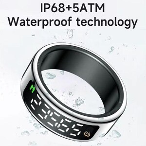 May include: A silver-toned smart ring with a black inner band and a digital display showing white segmented numbers. The text IP68+5ATM Waterproof technology is visible above the ring, which is surrounded by floating water droplets.