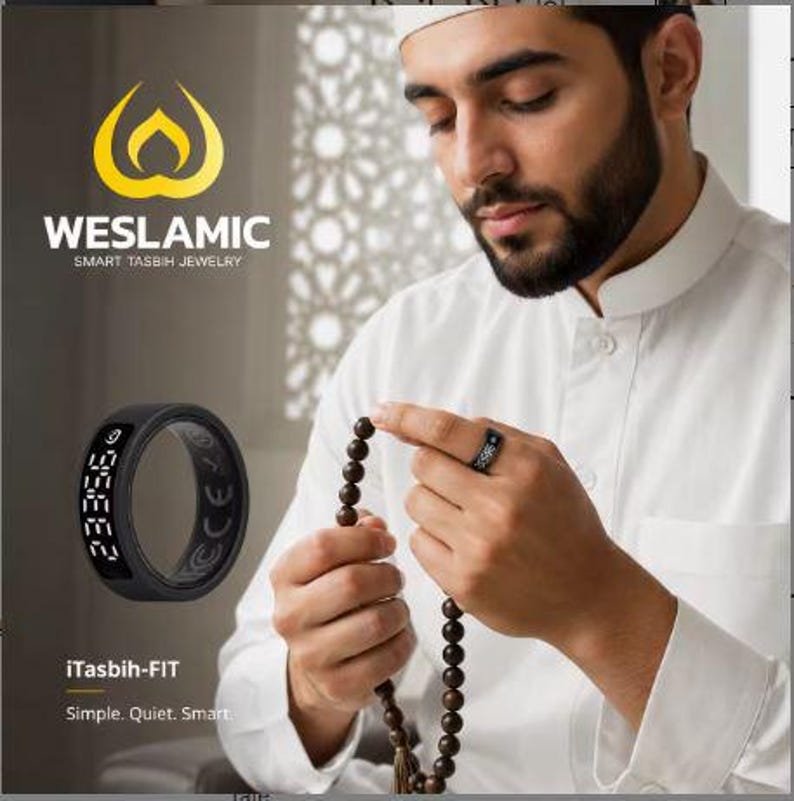 May include: A black smart ring with a digital display showing numbers, branded as iTasbih-FIT by WESLAMIC. The ring features a circular band design with a screen on the outer surface, presented alongside a person holding prayer beads.