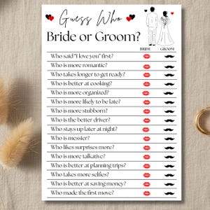 May include: A white card with the text "Guess Who Bride or Groom?" features a game with questions and spaces for lipstick and mustache answers. The top has heart and couple illustrations, perfect for a wedding or bridal shower activity.
