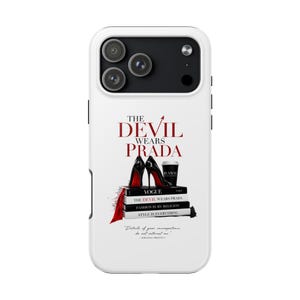 May include: White phone case featuring the text "The Devil Wears Prada" in red. The design includes black high heels, books, and a coffee cup. The case has a glossy finish and a protective bumper.