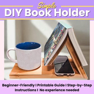 May include: A wooden DIY book holder with a book, a white mug with a blue interior, and a smartphone. The book is propped up, and the mug and phone sit on the wooden base. Text reads: Simple DIY Book Holder.