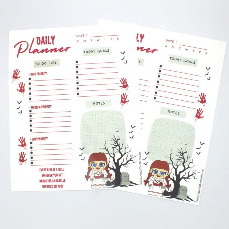 May include: Two white Daily Planner sheets with red accents. Each sheet has a to-do list, today goals, and notes section. The sheets feature a doll graphic, a tree, and the text "EVERY GIRL IS A DOLL WHETHER YOU GET BARBIE OR ANNABELLE DEPENDS ON YOU!"