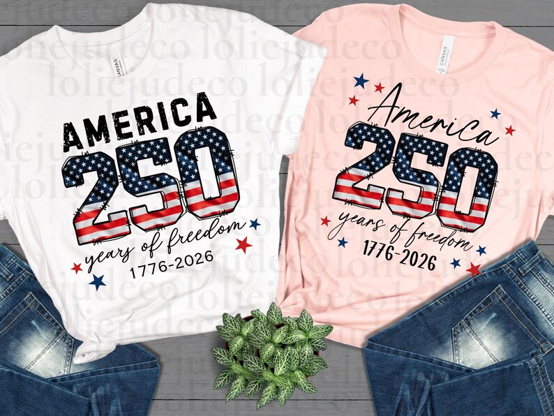 May include: A white t-shirt and a light pink t-shirt, each featuring the text AMERICA 250 years of freedom 1776-2026. The number 250 is printed with a red, white, and blue American flag pattern, accompanied by small red and blue star graphics.