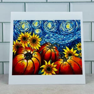May include: A framed art print featuring a vibrant painting of pumpkins and sunflowers under a swirling night sky. The pumpkins are orange and red, and the sunflowers are yellow. The sky is a deep blue with yellow stars.
