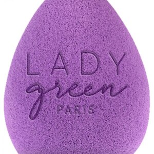 May include: A purple teardrop-shaped makeup sponge with the embossed text "LADY green PARIS". The sponge has a textured surface and is designed for applying cosmetics. The product is a beauty tool.