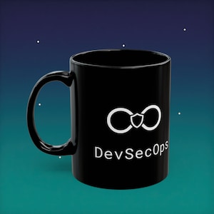 May include: Black ceramic mug with a white logo featuring two connected infinity symbols and a shield, with the text "DevSecOps" below. The mug has a curved handle and a glossy finish.