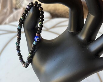 Black Seed Bead Bracelet: Glass Evil Eye, Iridescent Accents