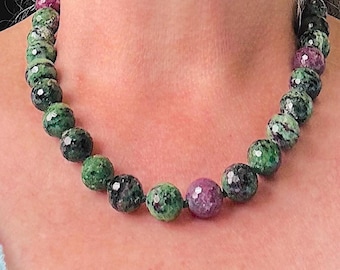 18 inch long faceted 12mm Ruby in Zoisite hand knotted necklace with a magnetic clasp. Preowned but Never Worn. Perfect condition. Gorgeous!