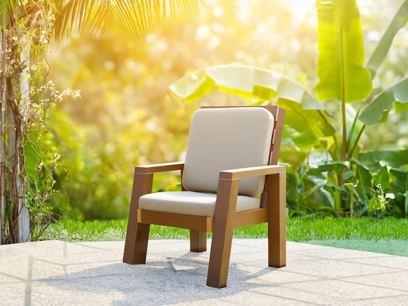 May include: A wooden outdoor chair with a light beige cushion and backrest. The chair has a brown frame and armrests. The background features lush green foliage and sunlight, suggesting a patio or garden setting.