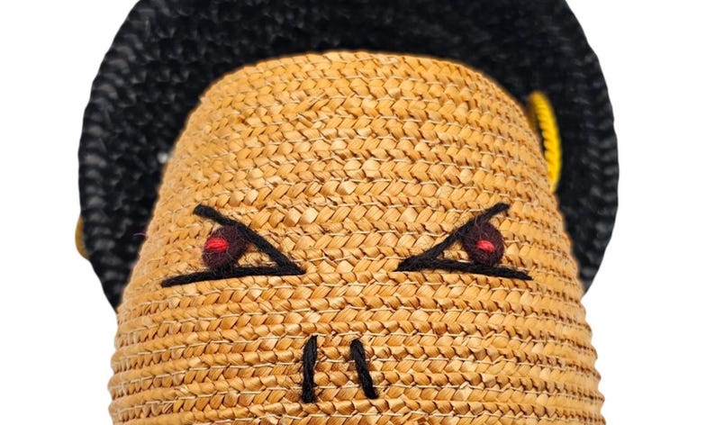 Detail of felt eyes and red wool embroidery on 1940s purse