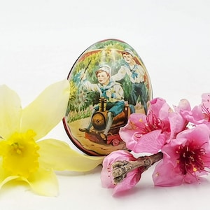 Vintage tin Easter egg Ian Logan design Swiss made with decoration of Victorian era children playing, vintage tin Easter egg