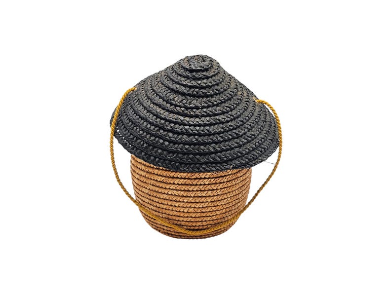 Back view of woven straw barrel shaped handbag