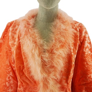 Vintage robe for woman, Italian origin, dating to 1960s in salmon color velvet with devorè floral motif, edged with ostrich feathers, size L.