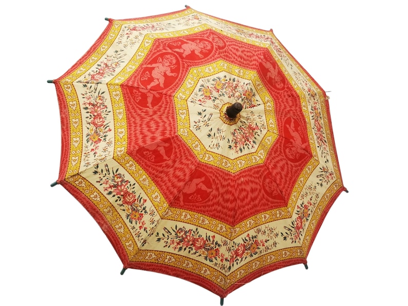 Antique French child's parasol in cretonne fabric with a design of floral garlands and cherubs in oval medallions, in tones of coral, pink, beige, honey and sage green, wooden handle with hand painted face.