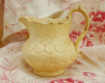 Antique French fine earthenware jug, pitcher, butter color pitcher with raising design of daisies, David Johnston, Bordeaux faience fine jug