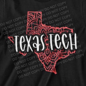 May include: Black t-shirt featuring a red outline of the state of Texas with a decorative interior design. The words "Texas Tech" are printed in white across the center of the design. The shirt is a short-sleeved crew neck.
