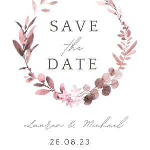 May include: A wedding invitation featuring a watercolour floral wreath in pink and brown hues. The text "SAVE the DATE" is central, with the names "Lauren & Michael" and the date "26.08.23" beneath. The bottom text reads "FORMAL INVITATION TO FOLLOW."