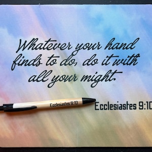 May include: A rectangular mouse pad with a soft-focus, multicoloured sky background featuring the black text "Whatever your hand finds to do, do it with all your might." and "Ecclesiastes 9:10". A light-coloured pen with black trim rests on it.