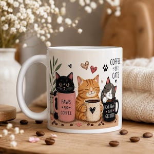 May include: White ceramic coffee mug featuring three cartoon cats with coffee cups. The mug has the text "Coffee & Cats" and "Paws and Coffee" and "Cat Hair is my Glitter". The cats are black, orange, and gray, with hearts and paw prints.