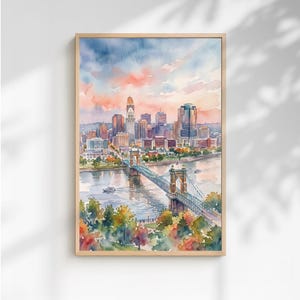 May include: A watercolour painting of a city skyline at sunset, featuring a prominent suspension bridge spanning a river. The scene includes tall buildings, lush green and orange trees in the foreground, and a soft, colourful sky with pink and blue hues.