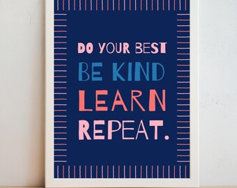 May include: A framed print with a navy blue background and white border. The text "DO YOUR BEST BE KIND LEARN REPEAT" is displayed in pink, blue, and coral lettering. The print is displayed on a wooden surface.