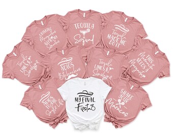 May include: A collection of pink t-shirts with white text and graphics, including phrases like "Tequila Squad" and "My Final Fiesta". One white shirt is also included. The shirts are likely for a bachelorette party or similar event.